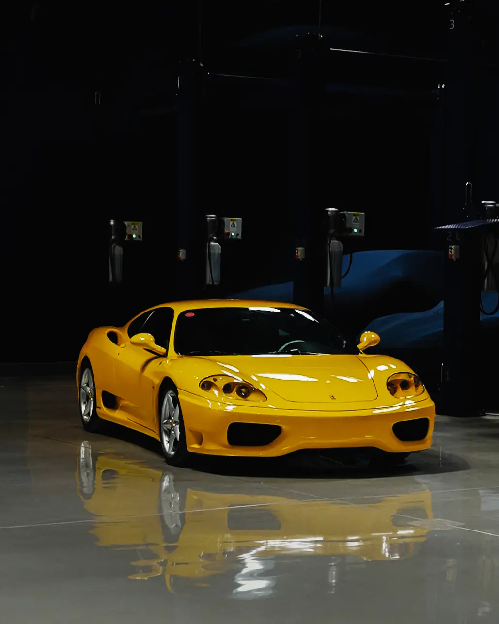 A collector car standing under low light inside The Collectors Hangar, the sealed and climate-controlled private car storage facility in Dubai